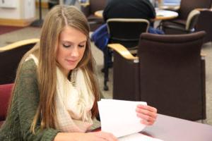 Student looks over her notes in the library
